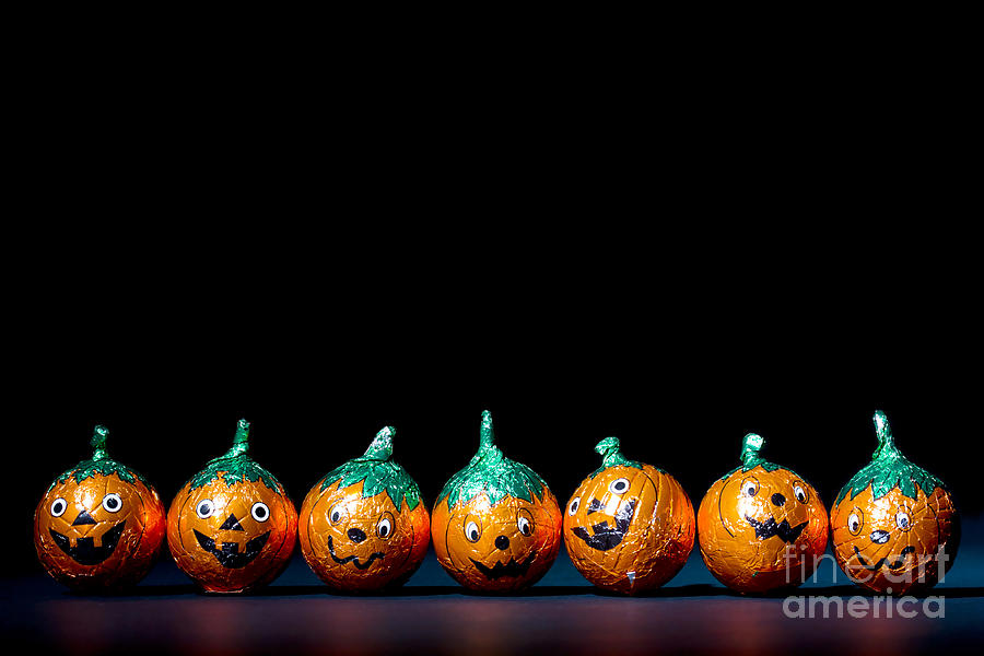 Orange pumpkin chocolates Photograph by Simon Bratt