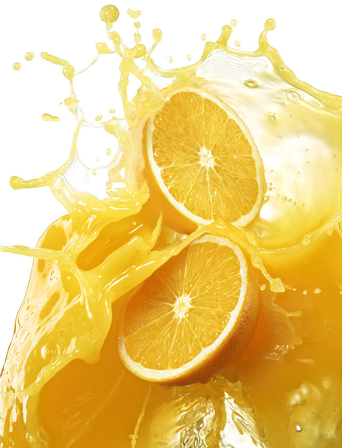 Oranges with splashing orange juice. Photograph by Jack Andersen