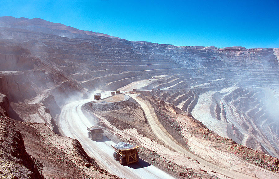 Ore trucks in an open-pit mine Photograph by Robas