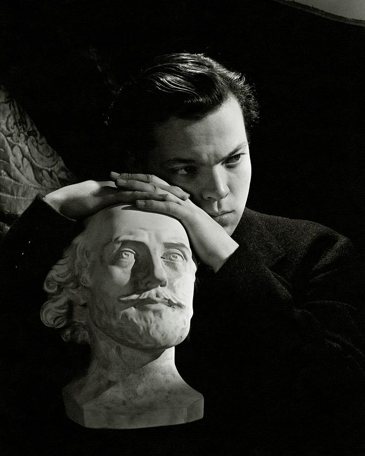 Orson Welles Resting On A Sculpture Photograph by Cecil Beaton