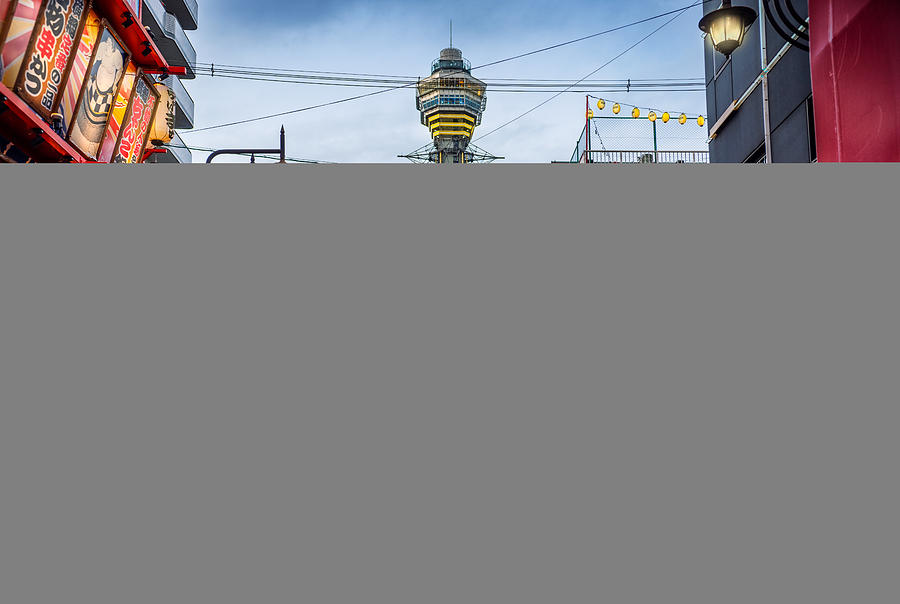 Osaka Tower and view of the neon advertisements in Shinsekai district at dusk, Osaka, Japan Photograph by Eloi_Omella