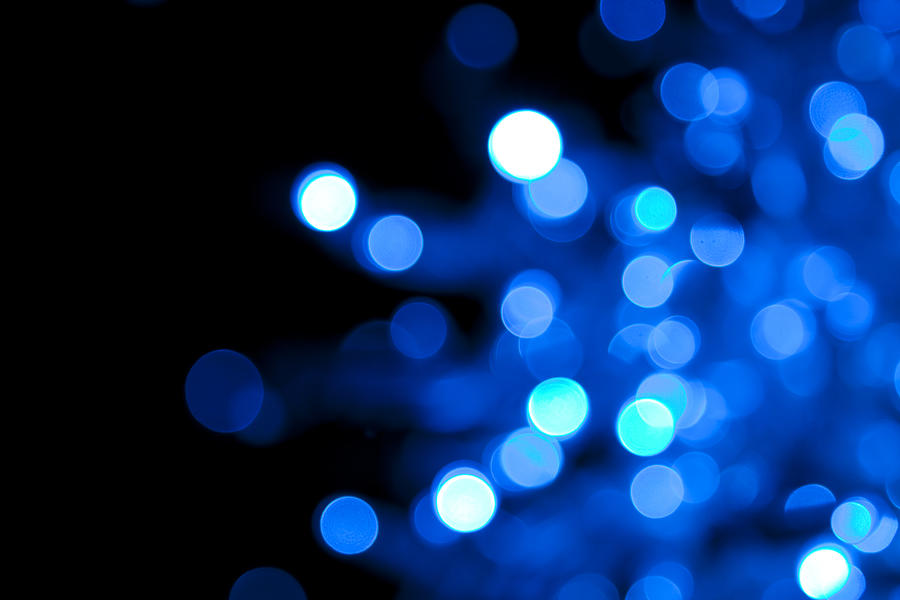 Out of focus illuminated blue dots on black background Photograph by Sebastian-julian