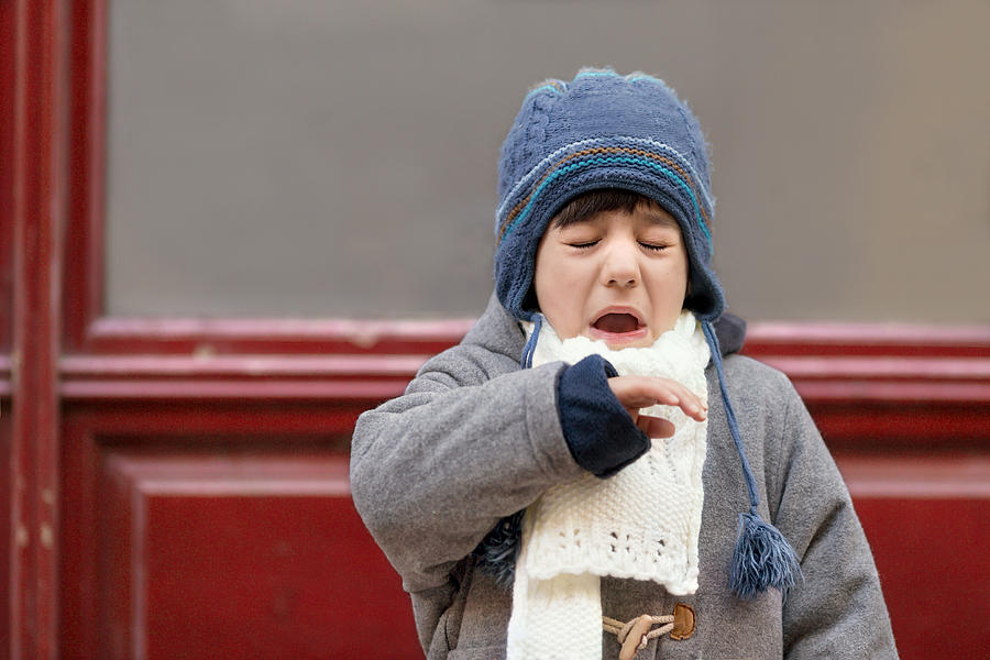 Outdoor portrait of sneezing boy Photograph by Anna Pekunova