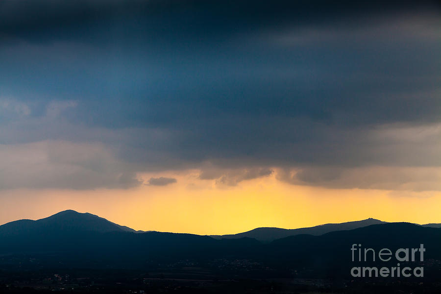 Overcast Dark Sky Rain Clouds With Yellow Glow Beyond Hills On H Photograph by Peter Noyce
