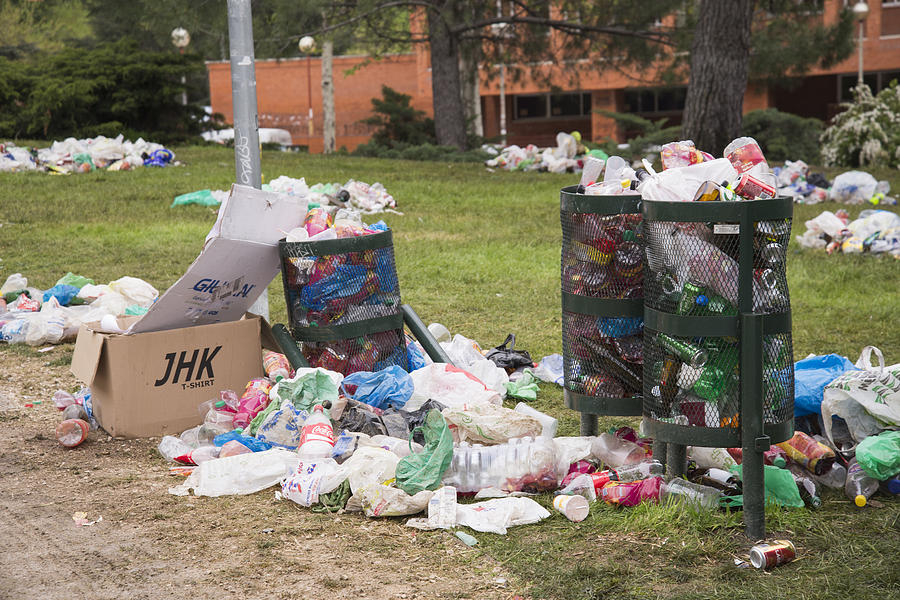 Overflowing bins in a park of Ciudad Universitaria, Madrid Photograph by Carlos Ciudad Photos