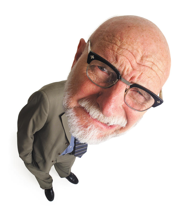 Overhead Shot Of Elderly Bald Business Man With Glasses Leans To The Side And Grimaces Into Camera Photograph by Photodisc
