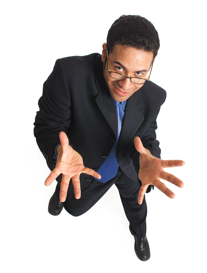 Overhead View Of A Young Latin Man In A Black Suit And Blue Tie Wearing Glasses Who Dances And Holds His Hands Out While Looking Up Into The Camera Photograph by Photodisc