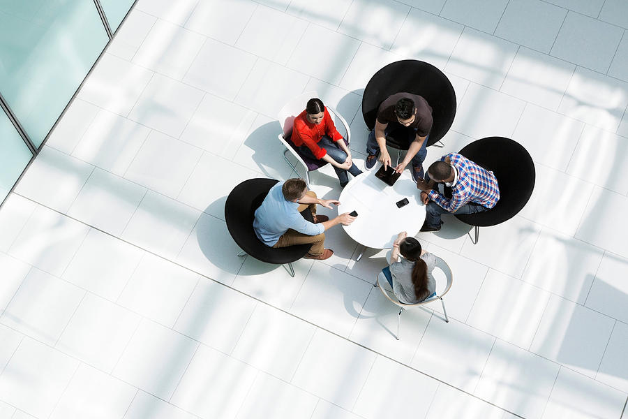 Overhead view of colleagues in meeting Photograph by Image Source