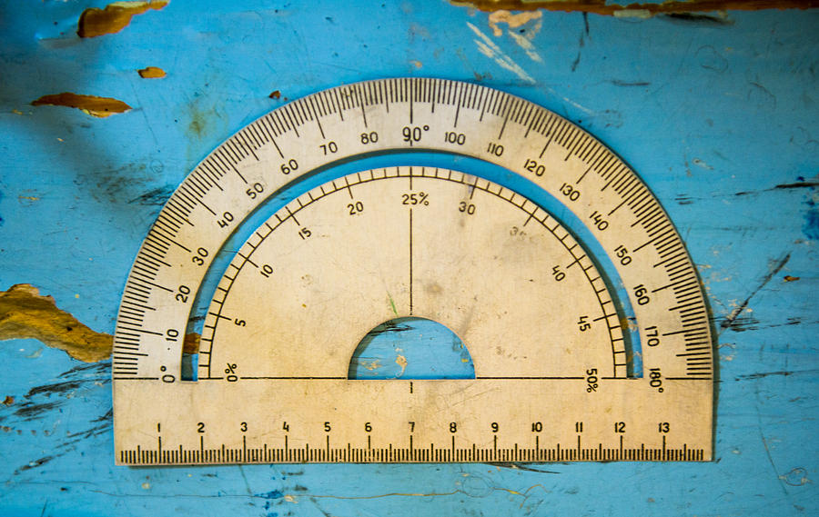 Overhead view of vintage protractor on blue table Photograph by Aleksander Rubtsov