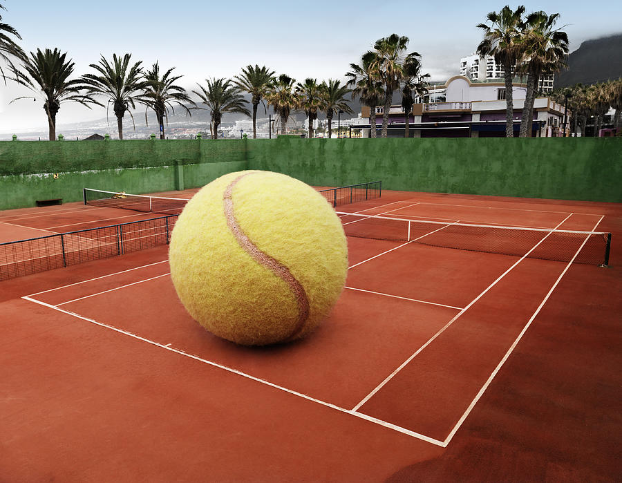 Oversized ball on an outdoor tennis court Photograph by Henrik Sorensen