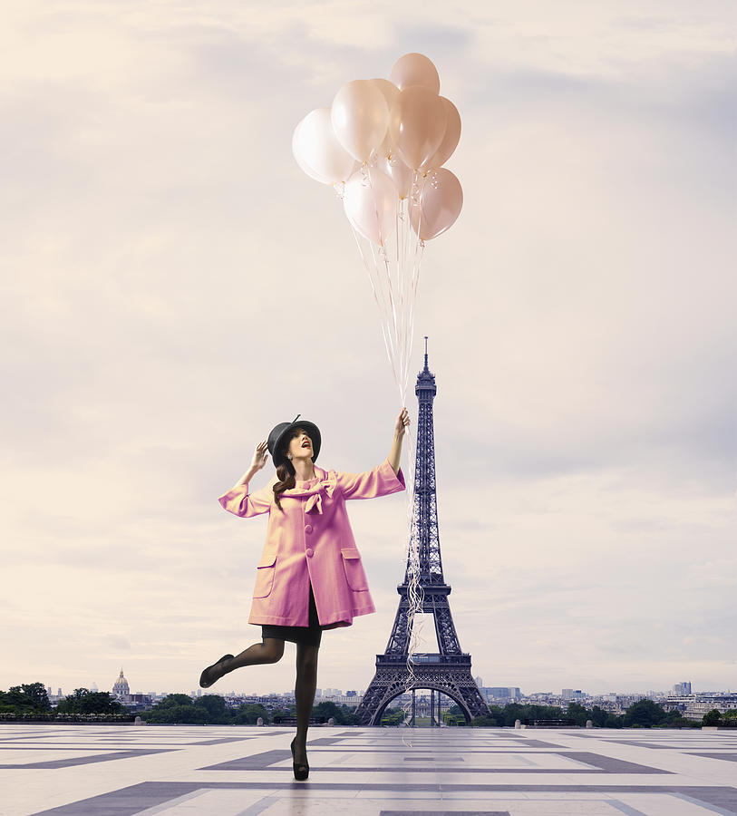 Pacific Islander woman with balloons near Eiffel Tower, Paris, Ile Photograph by Colin Anderson Productions pty ltd