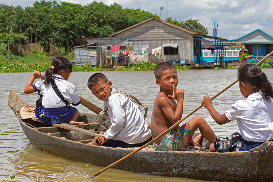 Paddling home from school Photograph by David Freuthal