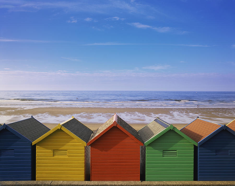 Painted Beach Huts in a Line, Whitby, England, UK Photograph by Peter Adams