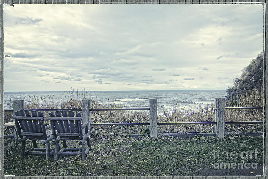 Pair of Wooden Chairs Overlooking Ocean on a Cold Grey Afternoon Photograph by Beverly Claire Kaiya