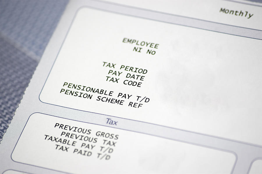 Paper pay slip with tax and pension information Photograph by Tattywelshie