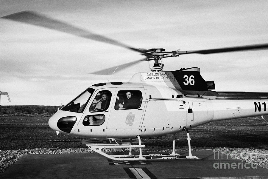 Grand Canyon National Park Photograph - papillon helicopter tours full of passengers ready for takeoff helipad Grand canyon west airport Ari by Joe Fox