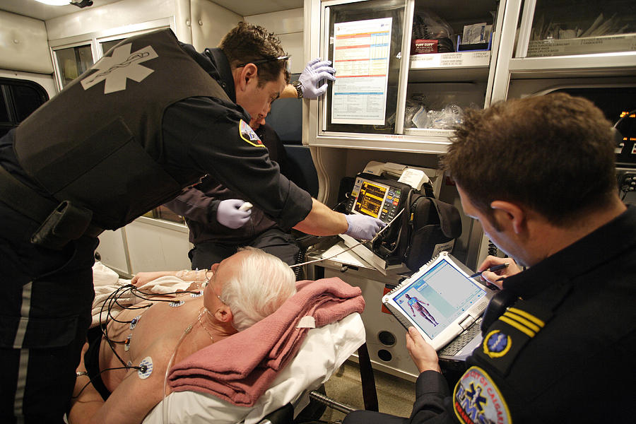 Paramedics Caring For Cardiac Patient Photograph by Kevin Link