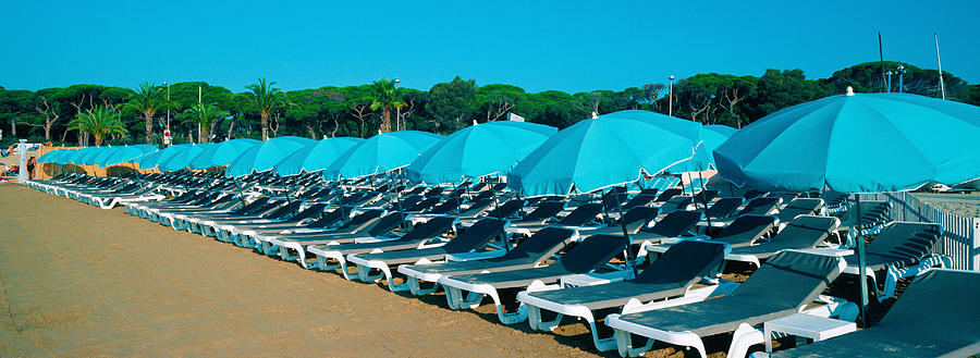 Summer Photograph - Parasols With Lounge Chairs by Panoramic Images