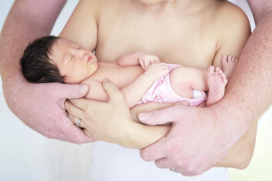 Parents Cradling Newborn Baby Girl Photograph by Ruth Jenkinson/science Photo Library