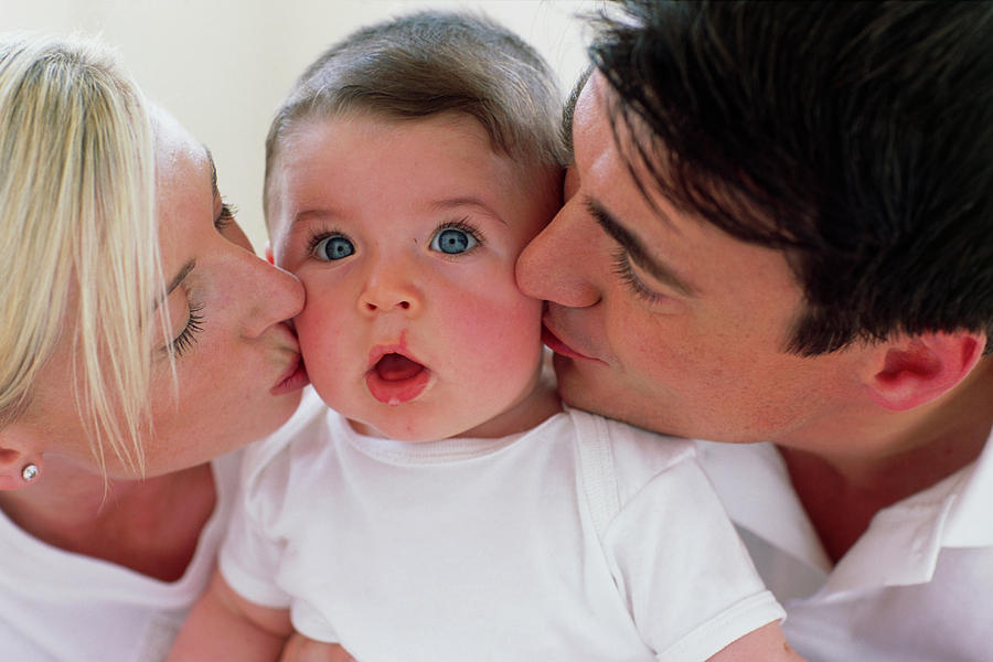 Parents Kissing Baby Boy Photograph by Ian Hooton/science Photo Library