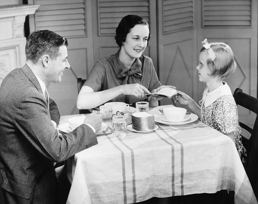 Parents with daughter (8-9) eating breakfast at home (B&W) Photograph by George Marks