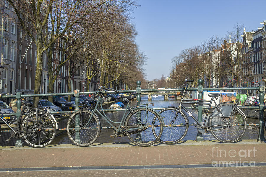 Parked bikes on a bridge in Amsterdam Photograph by Patricia Hofmeester