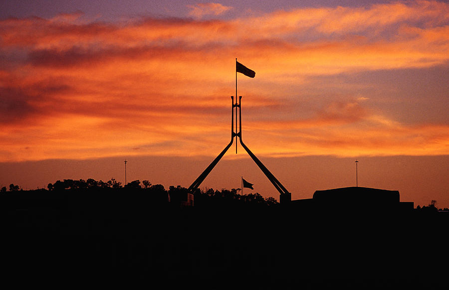 Parliament House flag silhouetted at sunset. Photograph by Richard IAnson
