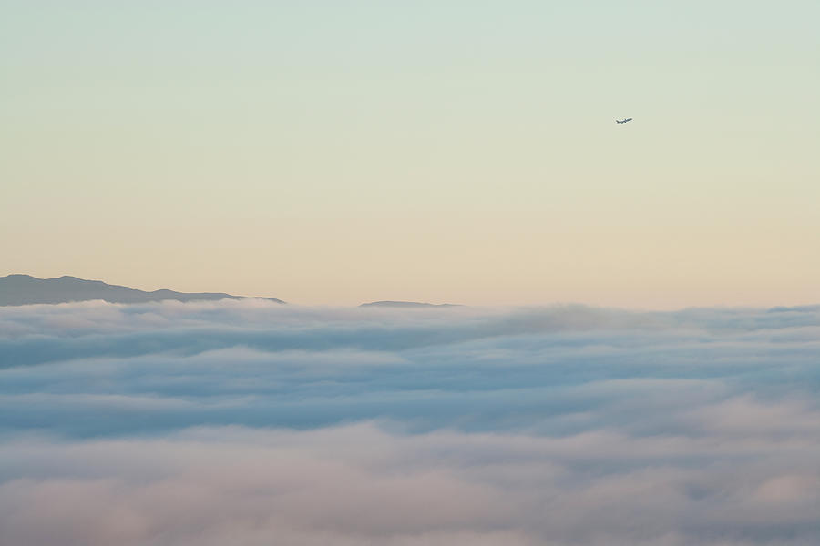 Passenger Jet Climbs Above Clouds And Photograph by Noah Clayton