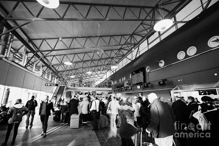 passengers queuing at check in desks in Tromso airport troms Norway ...