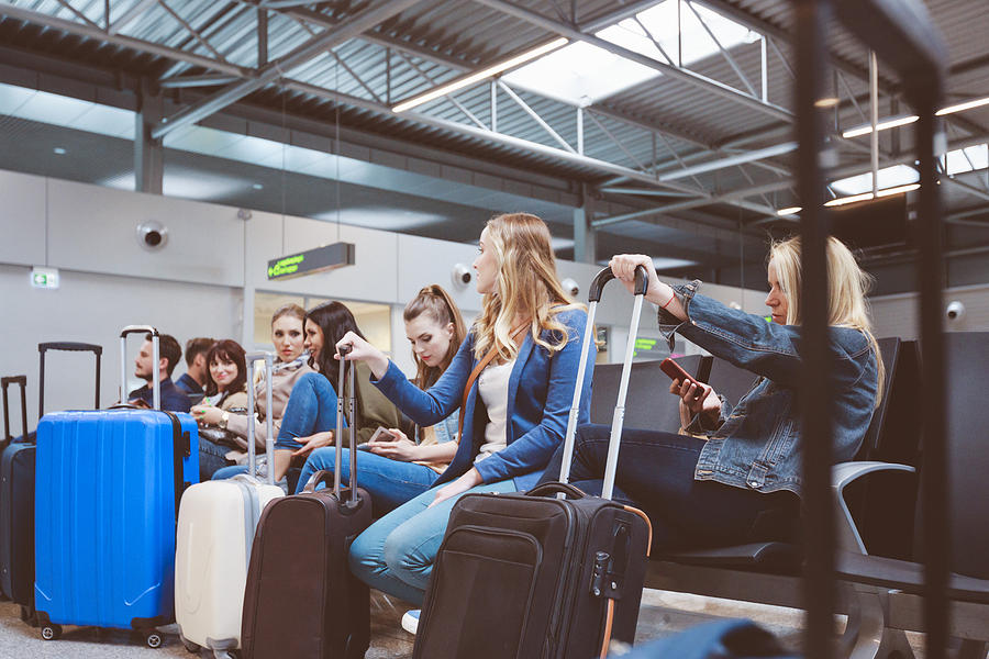 Passengers waiting at airport lounge Photograph by Izusek