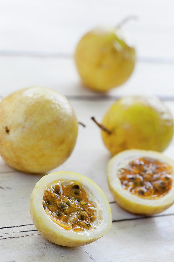 Passion Fruit On A Table Photograph by Enviromantic