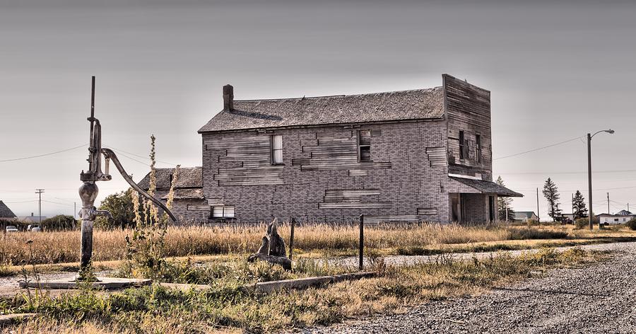 Old water pump and wooden building on Central Avenue, Moccasin, Montana, USA Photograph by Mick Flynn