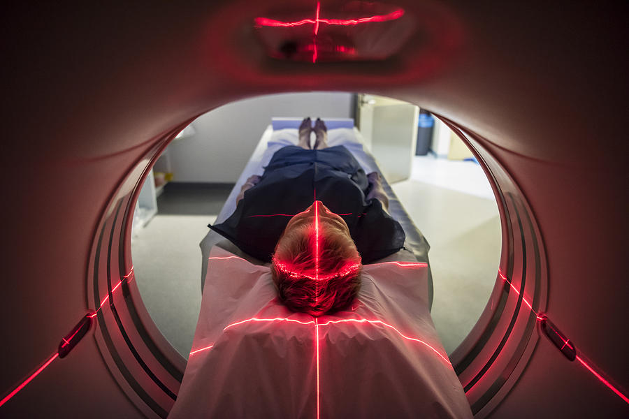 Patient lying inside a medical scanner in hospital Photograph by JohnnyGreig
