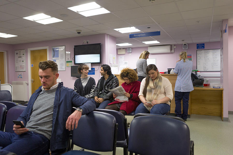 Patients in a Waiting room Photograph by SolStock