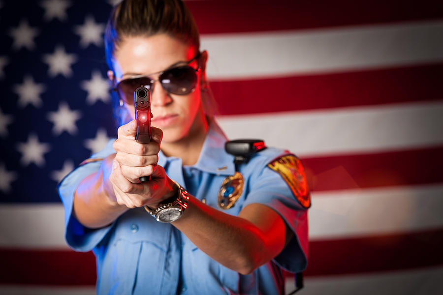 Patriotic Female Police Officer Aiming Handgun Photograph by Avid_creative