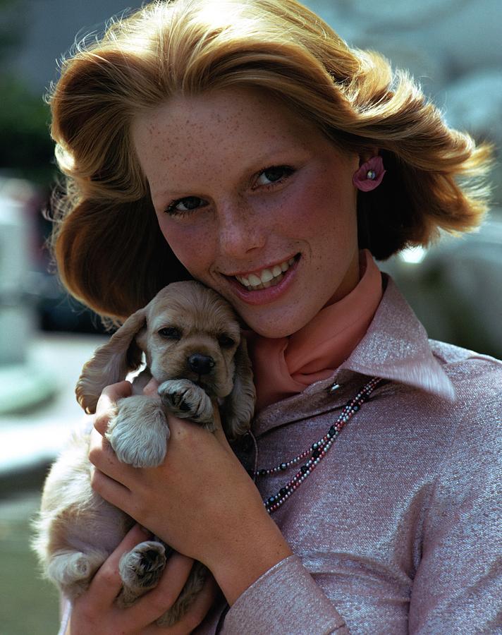 Patti Hansen Carrying A Puppy Photograph by William Connors