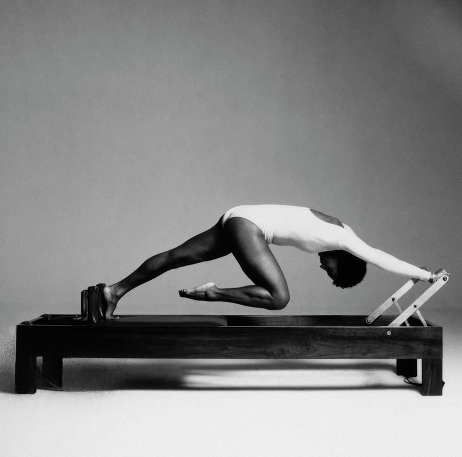 Paula Kelly Exercising On The reformer Machine Photograph by Francesco Scavullo