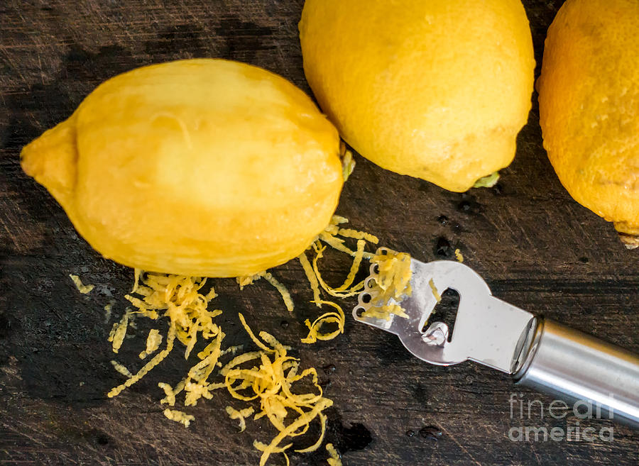Fruit Photograph - Peeling lemon rind to add zest by Frank Bach