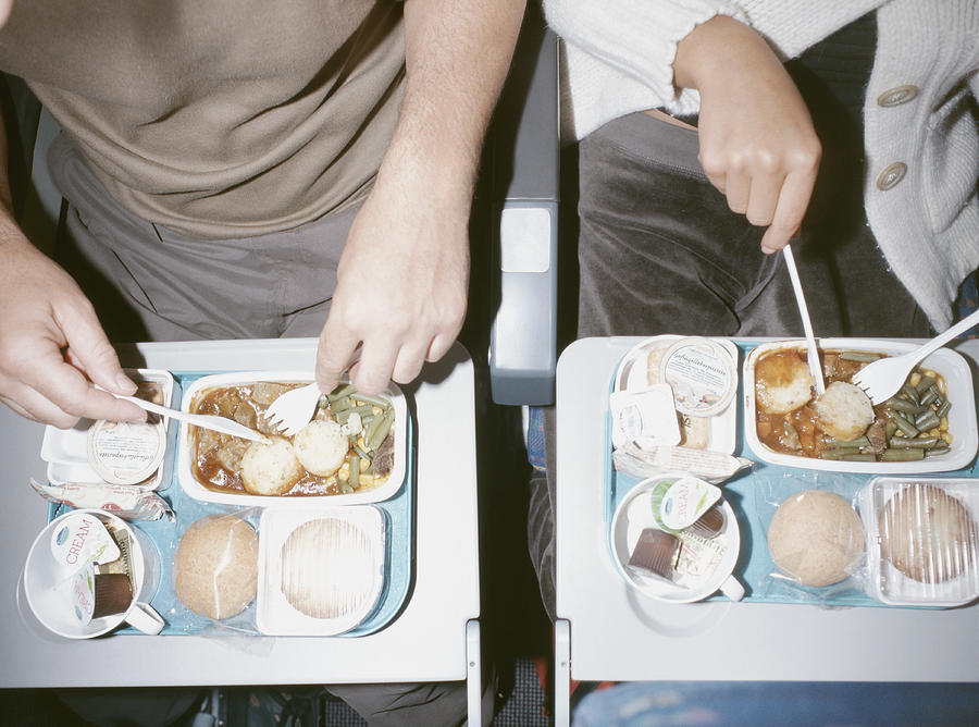 People Eating Airline Food Photograph by Peter Cade