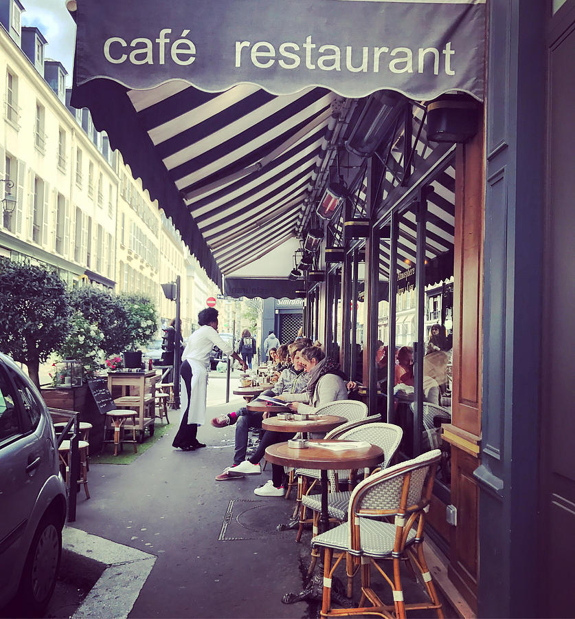 People eating outside in Paris cafe, France Photograph by Anouchka