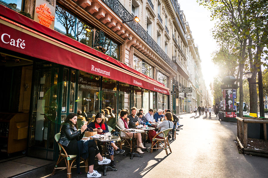 People relaxing, eating and drinking in restaurant in Paris, France Photograph by Anouchka