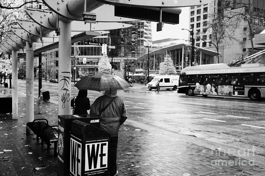 City Photograph - people standing in the rain waiting for a bus on burrard street downtown Vancouver BC Canada by Joe Fox