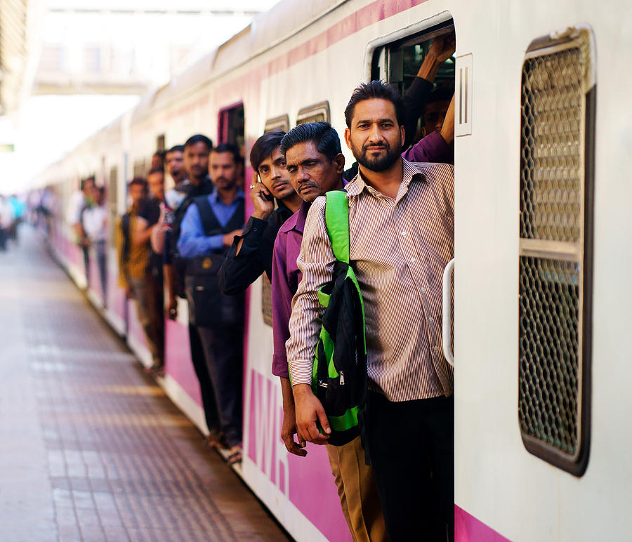 People travelling on local Indian train into Mumbai Photograph by Redtea