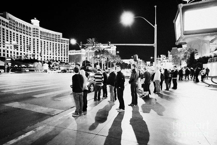 Las Vegas Photograph - People Waiting To Cross Las Vegas Boulevard Outside The Bellagio And Paris At Night Nevada Usa by Joe Fox