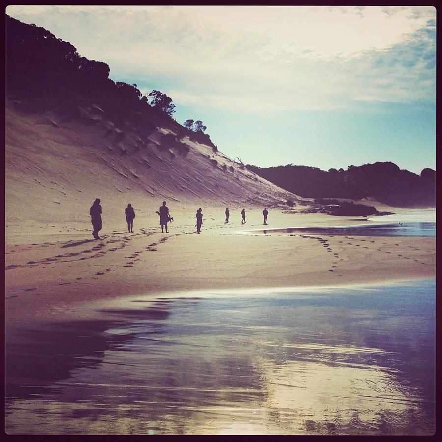 People Walking Along Beach At Secluded Photograph by Jodie Griggs