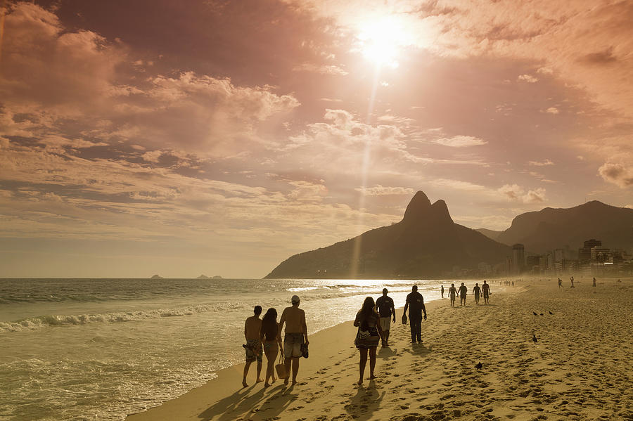 People Walking On The Beach At Sunset Photograph by Buena Vista Images