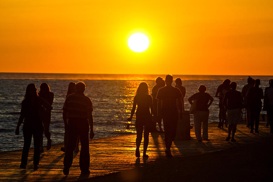 People walking on waterfront on sunset Photograph by Brch Photography