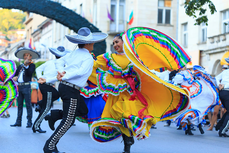 Performers from Mexican group in traditional costumes dancing on street Photograph by Valentinrussanov