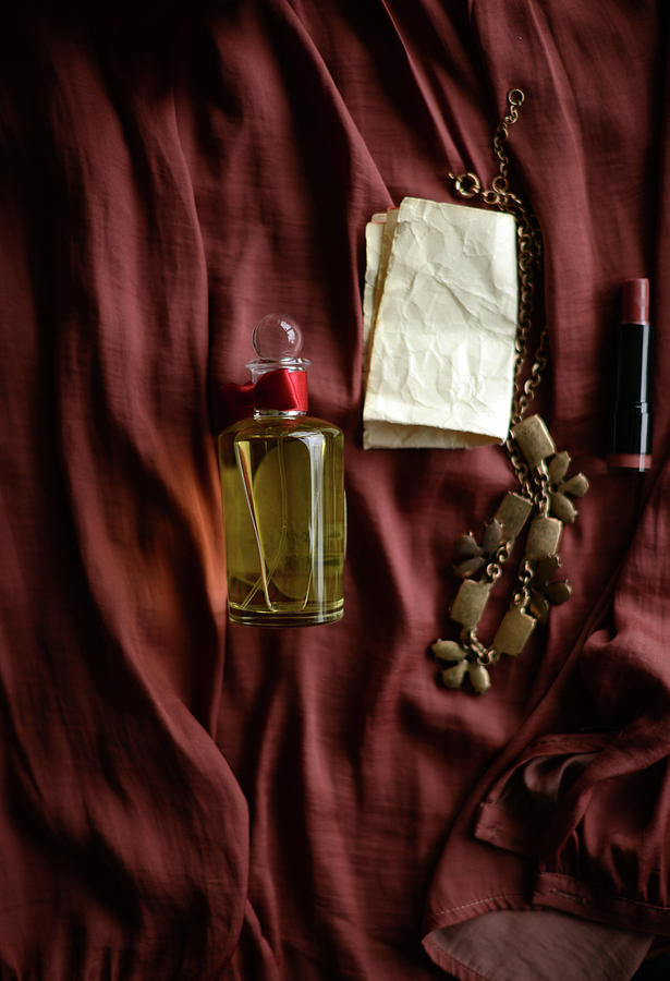 Perfume Bottle, Necklace And Lipstick Photograph by Kristina Strasunske