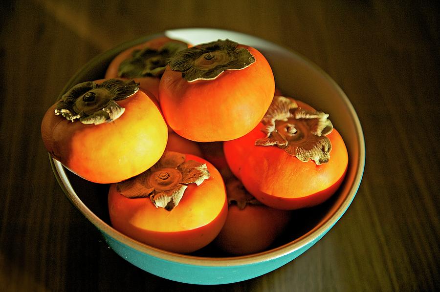 Persimmons In Blue Bowl Photograph by Hilary Brodey